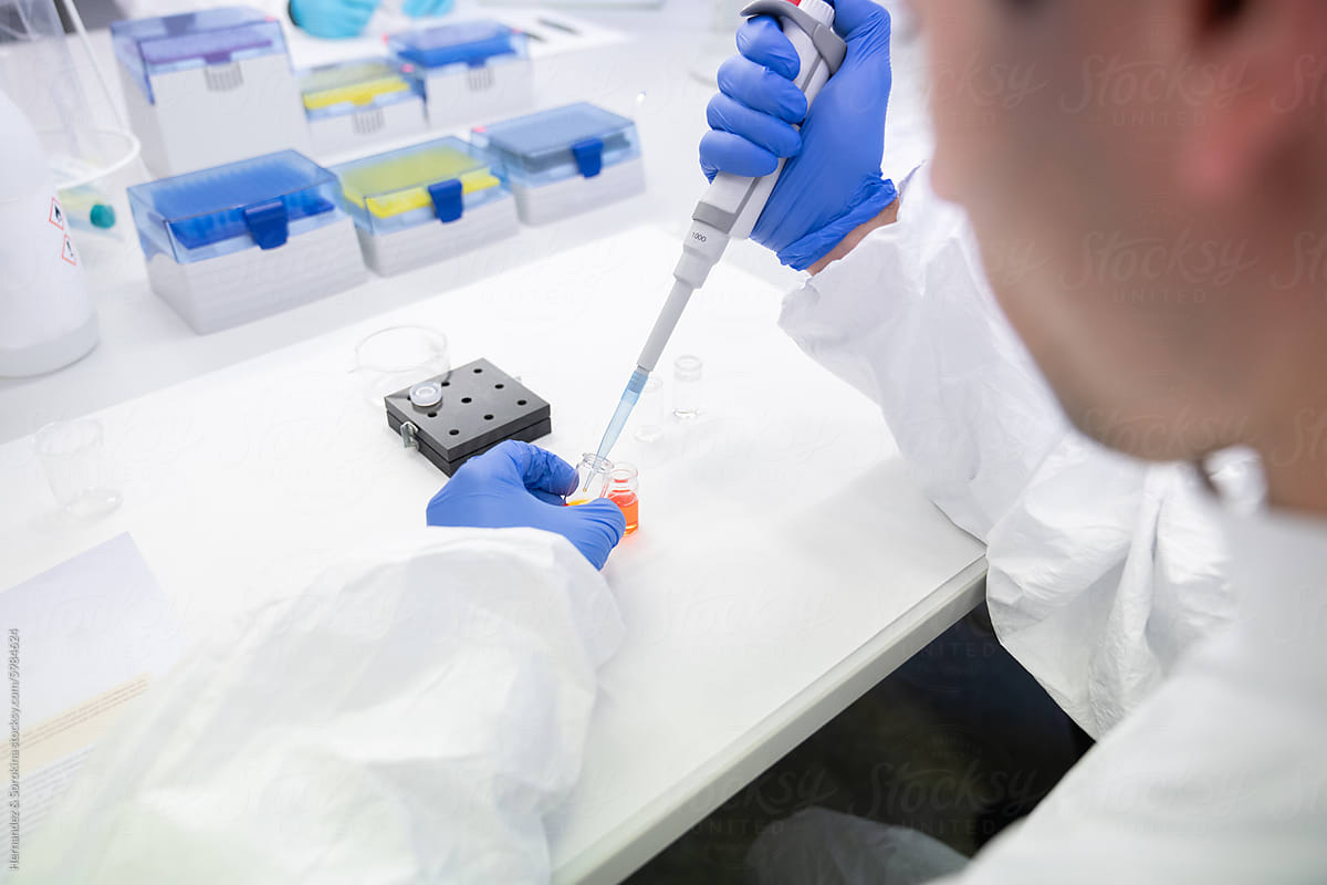Anonymous Researcher Working In Lab Using Pipette