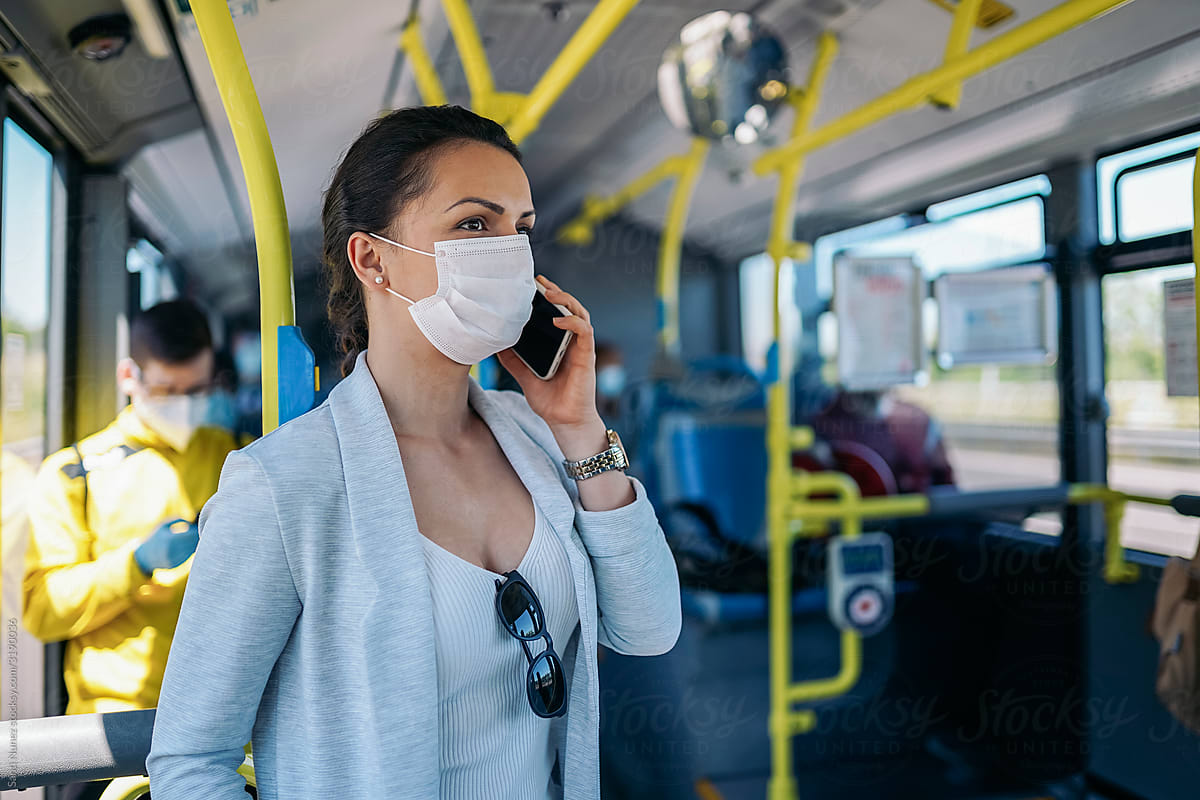 Woman covering her face with protective mask