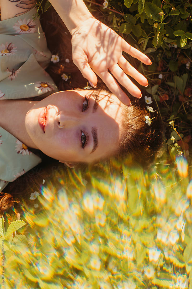 Young woman resting on grass on sunny day