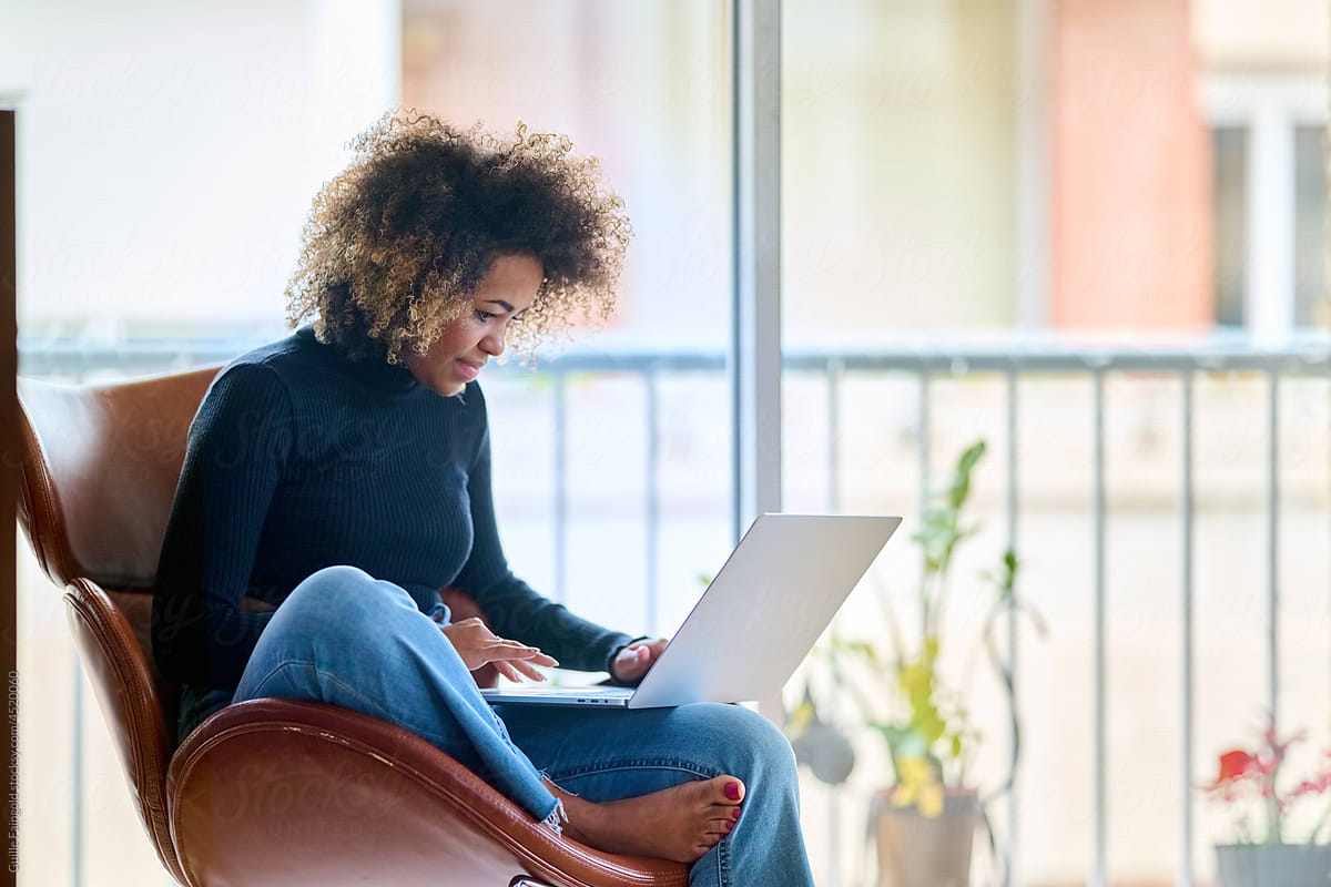 Female browsing netbook in daytime