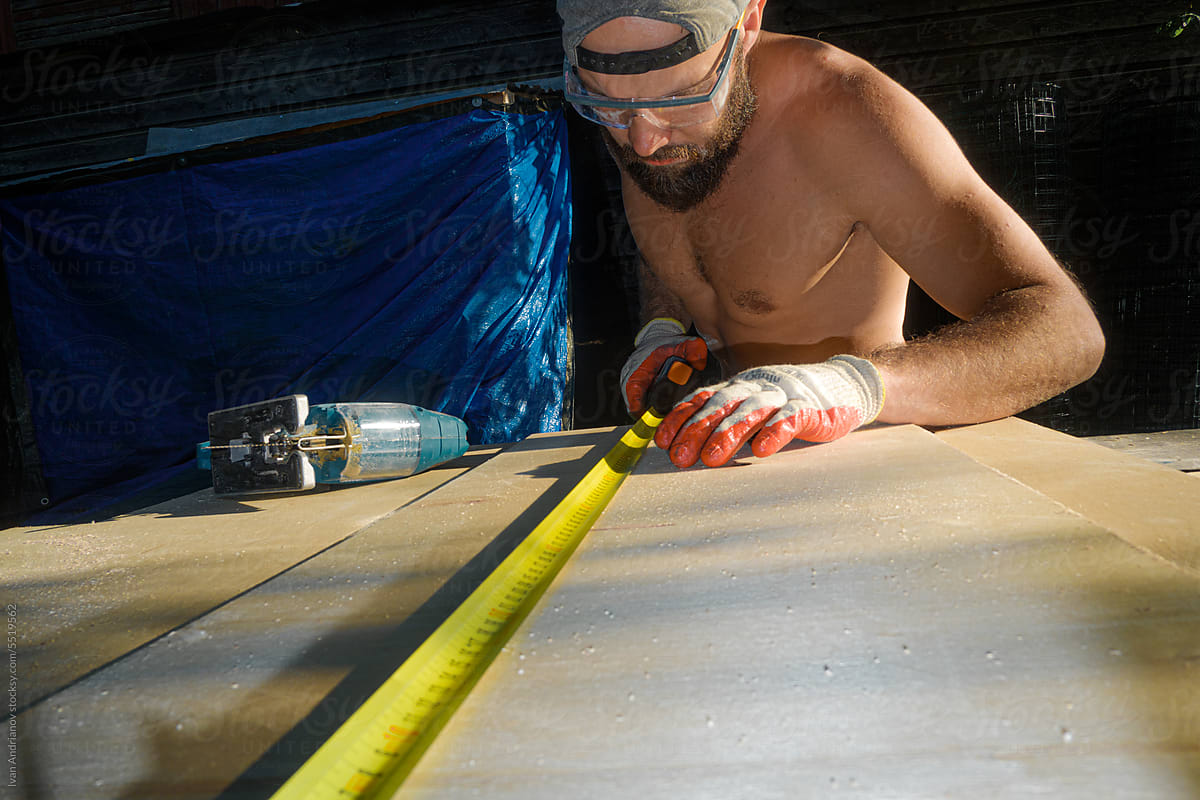 Shirtless Master Is Working With Construction Tool