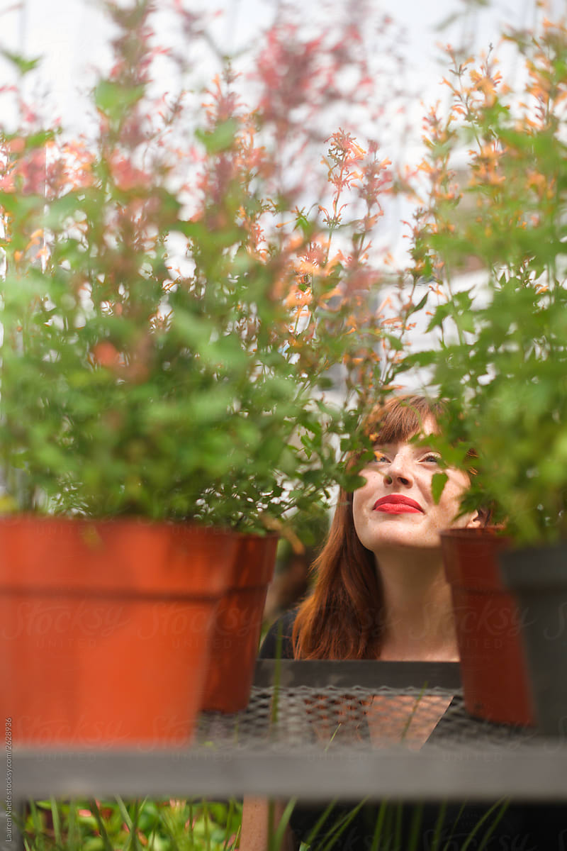 Young woman looking at plants