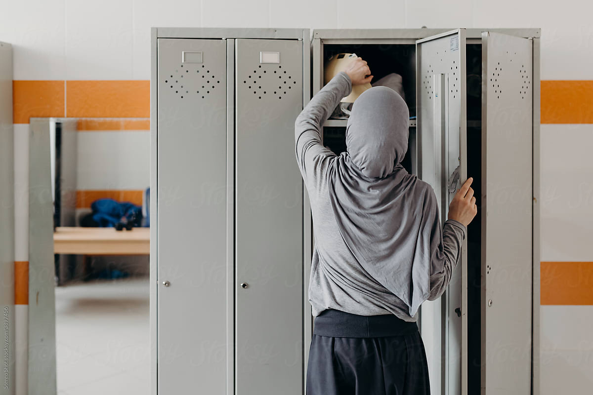 Muslim female fencer in locker room in gym