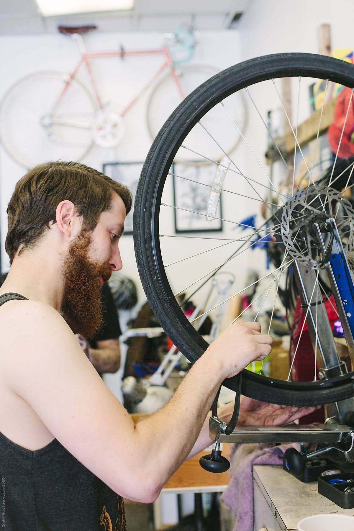 Bike Mechanic Works In A Shop