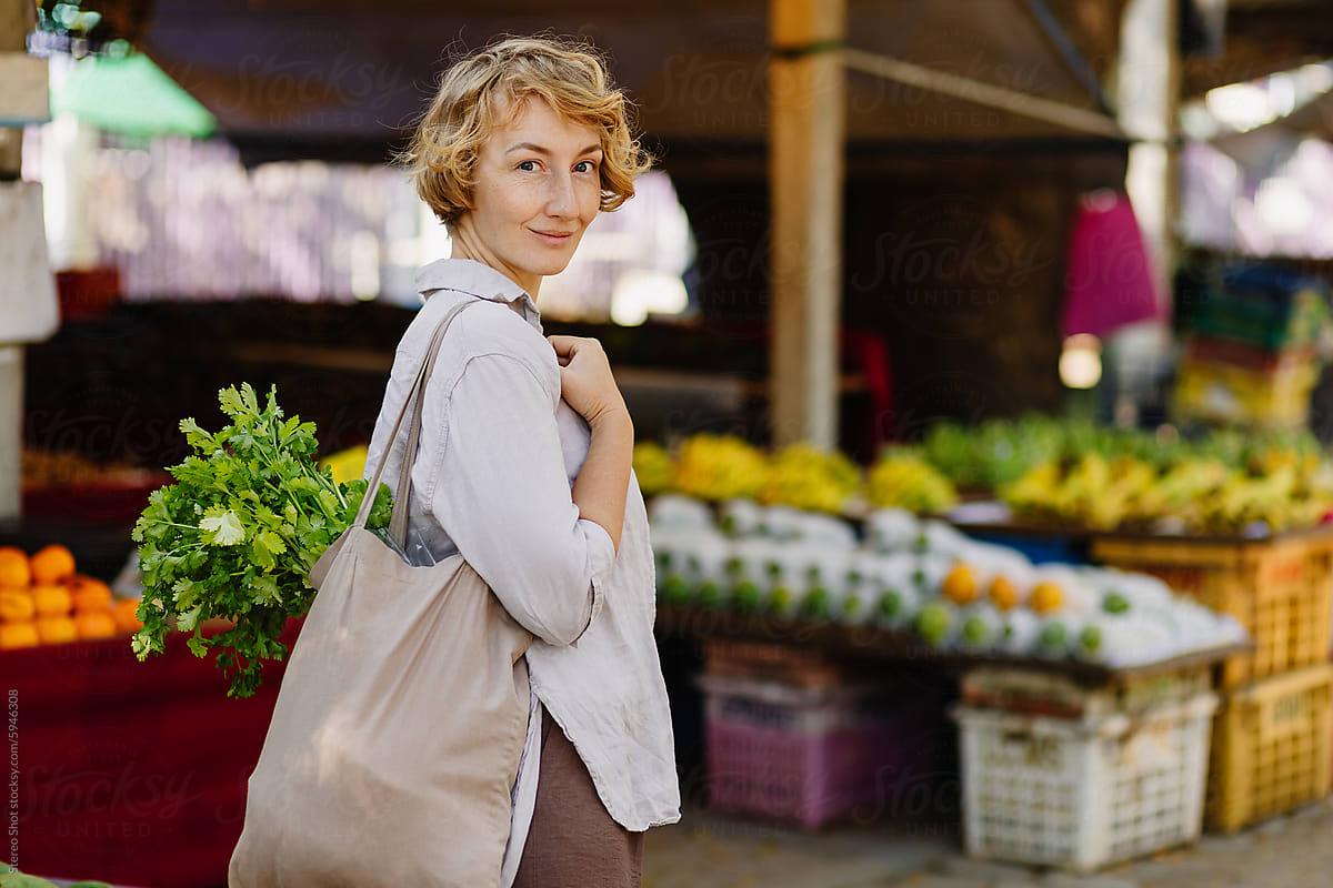 Pretty young woman standing in farmers market