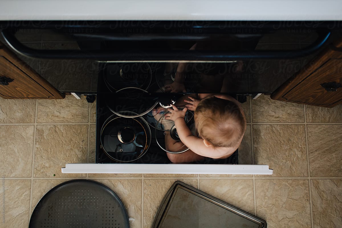 Toddler playing with pots and pans