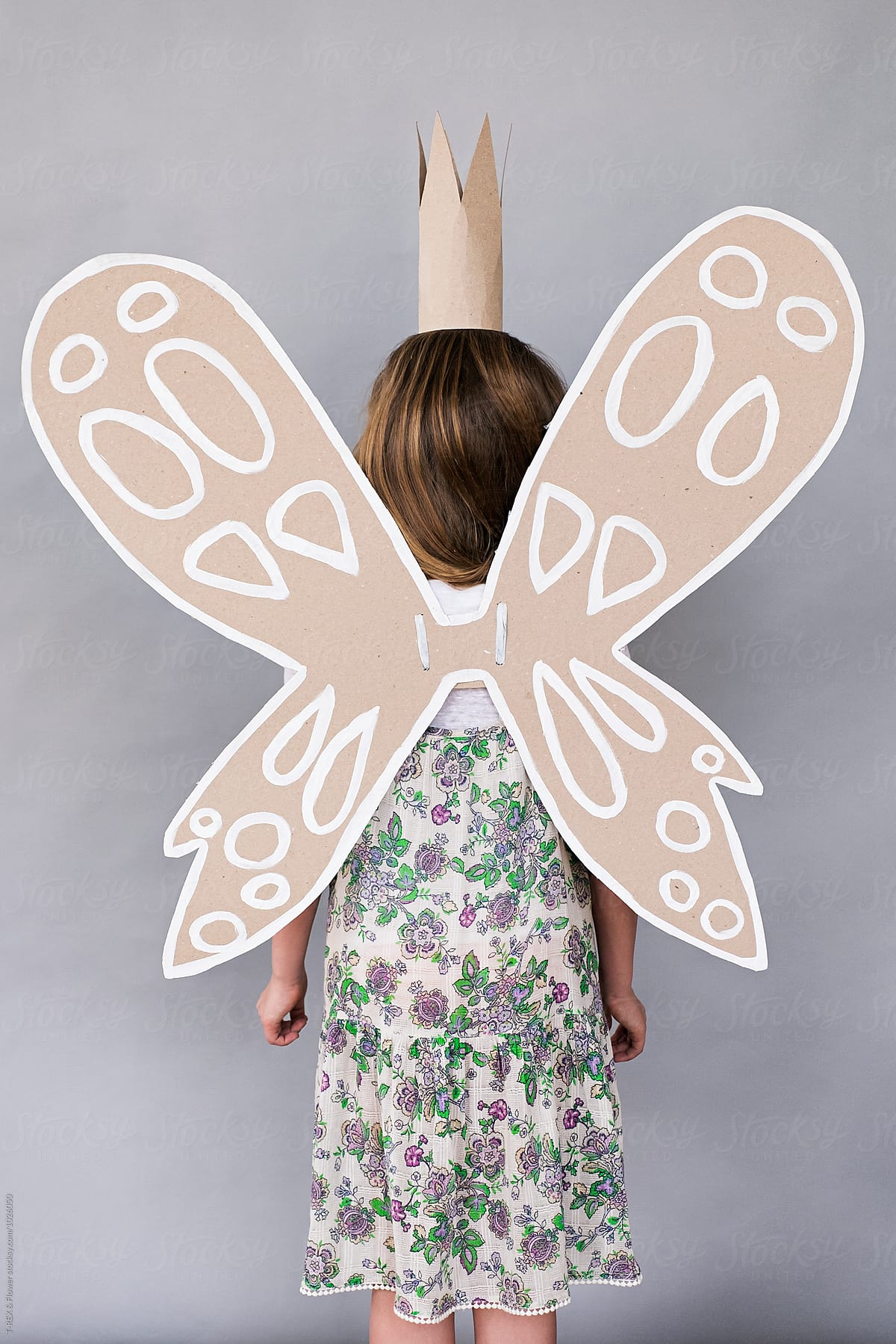 Unrecognizable girl with handmade butterfly wings and crown