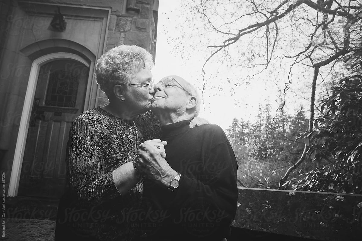 Romantic elderly couple kissing playfully