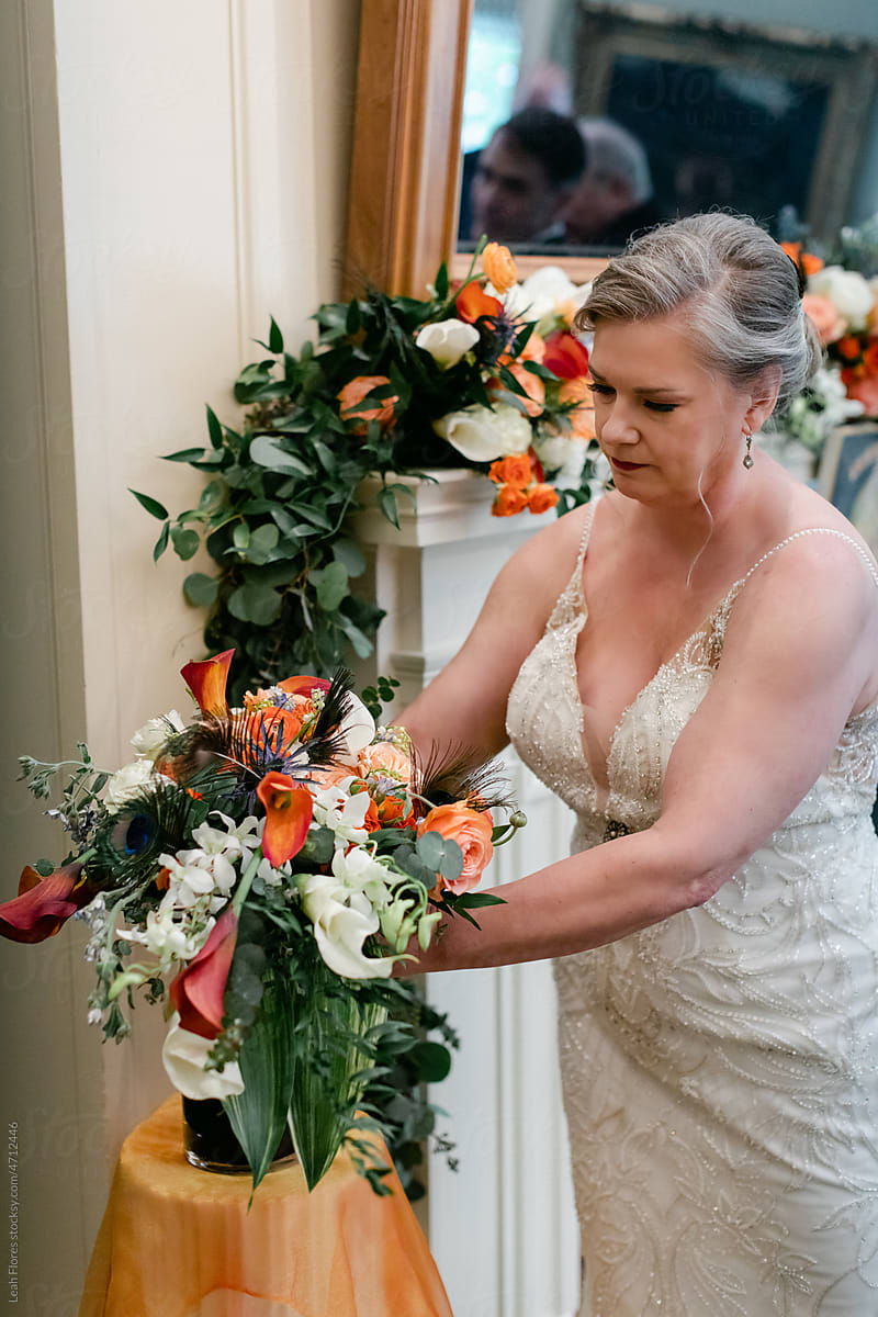 A Bride Adjusts a Floral Bouquet at Her Wedding