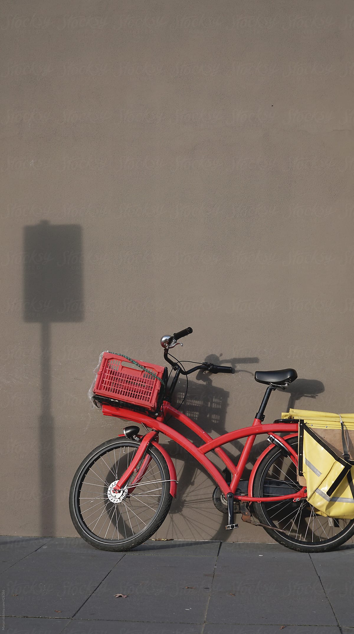 Red bicycle and the shadow of a traffic sign