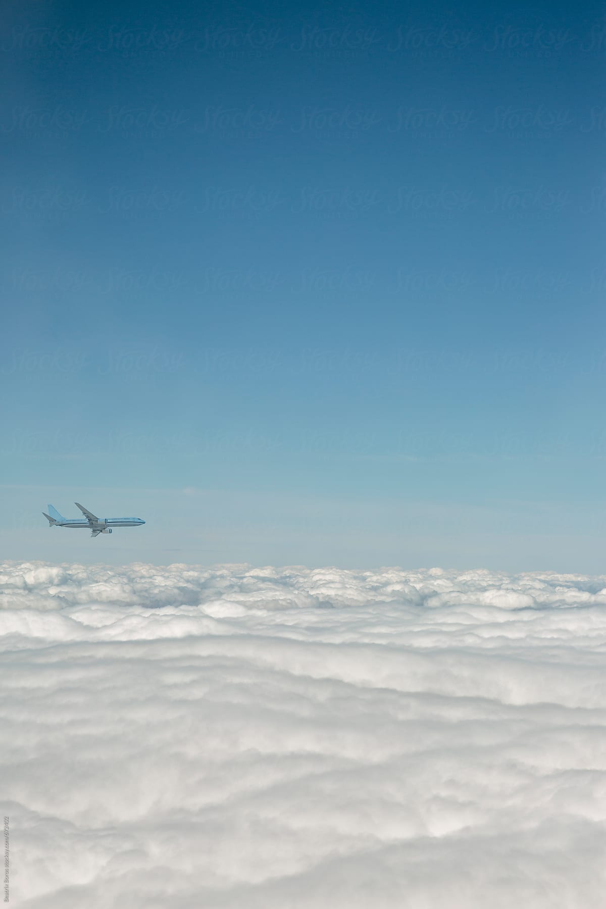 Aeroplane over the clouds flying in the sky towards its destination