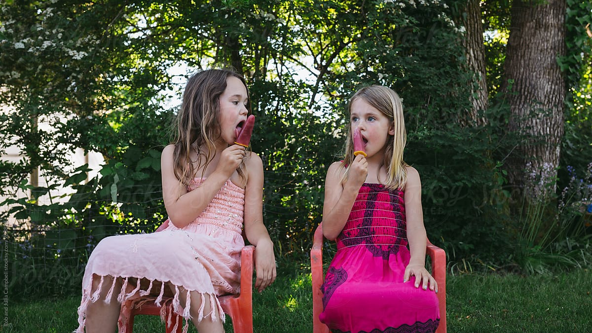 Cute Young Caucasian Girls Enjoying Popsicle Outside In Summer By Stocksy Contributor Rob And 