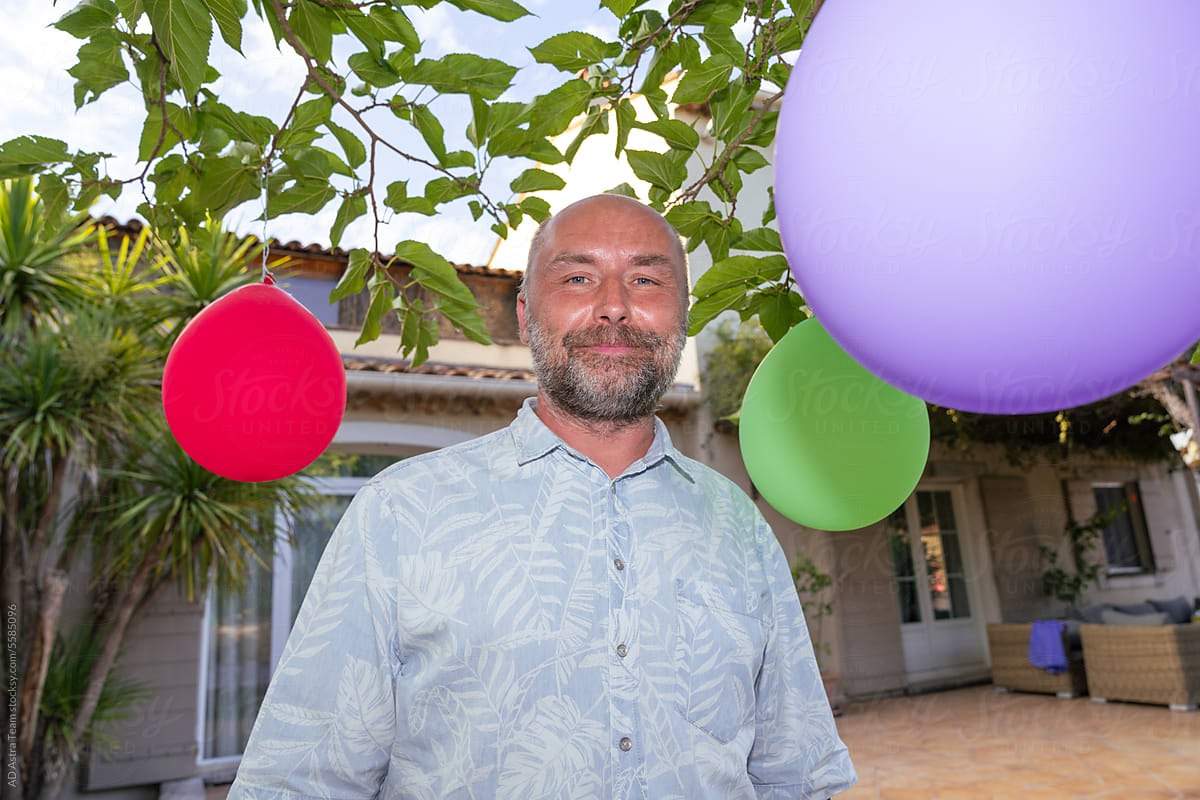 mature man with balloons