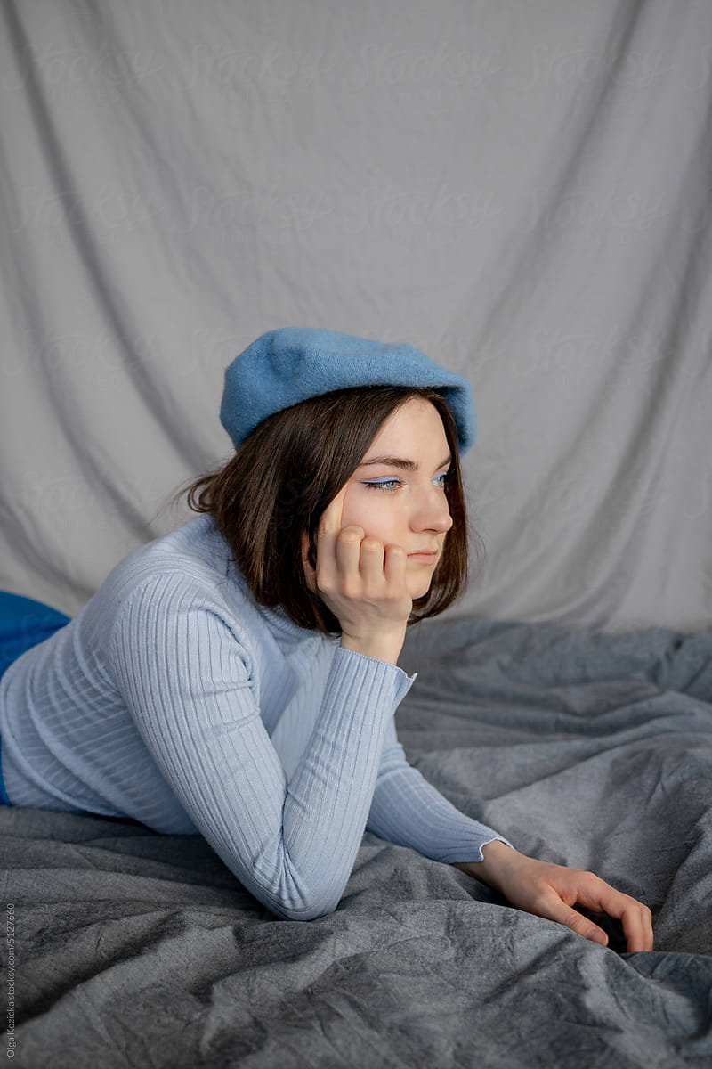 Bored Woman In Turtleneck and Beret Lying Down