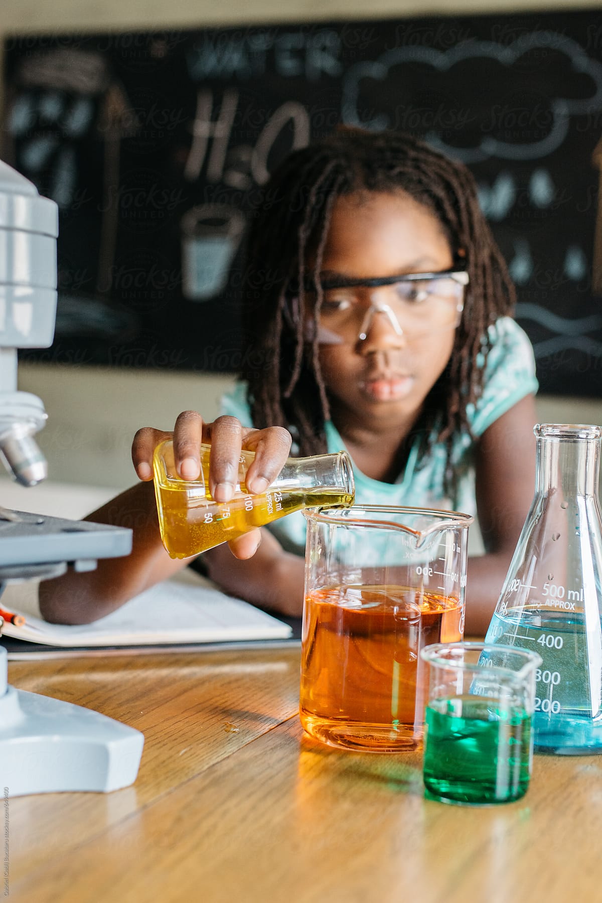 Black girl experimenting with liquids in a science class