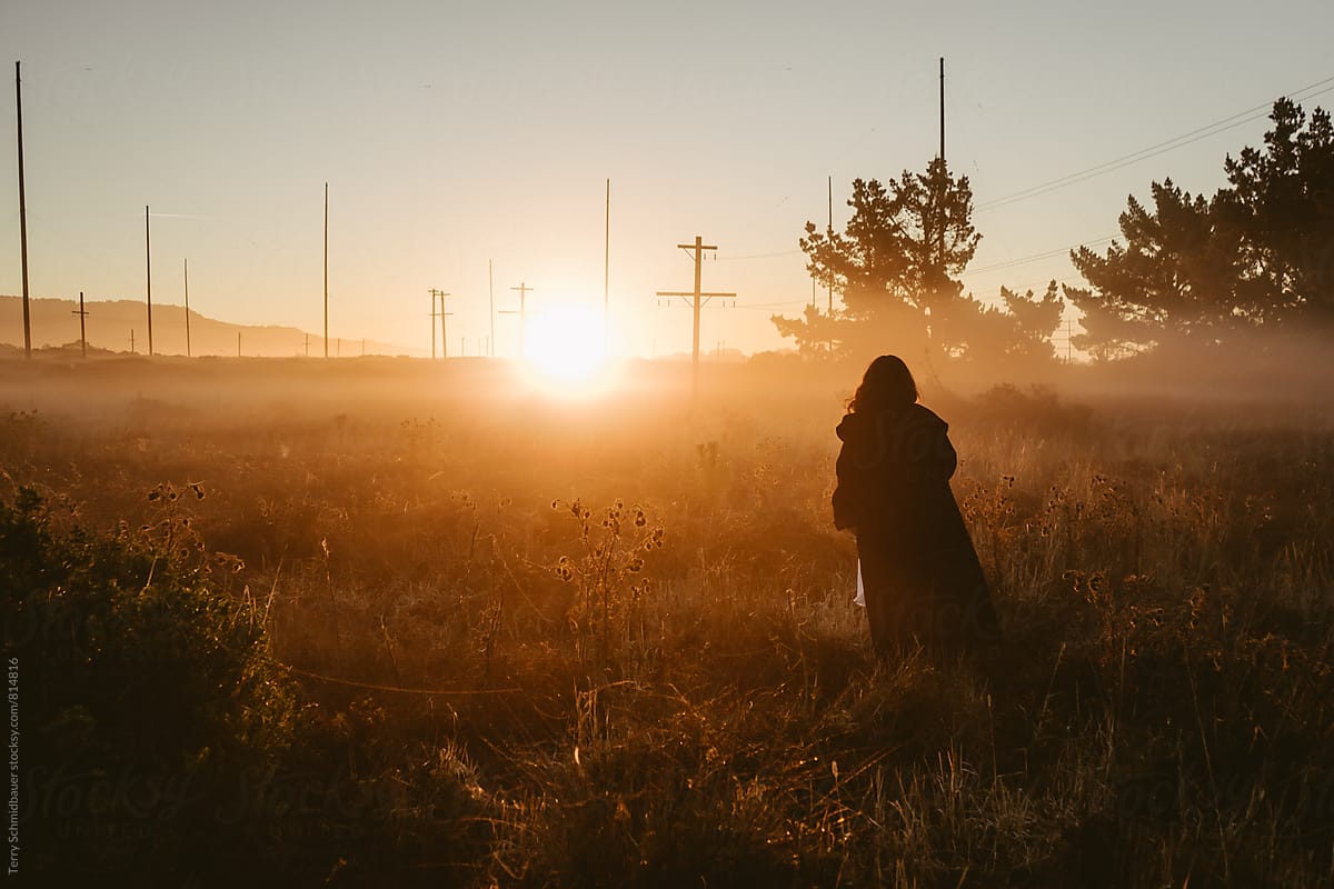 Woman in field at Sunrise