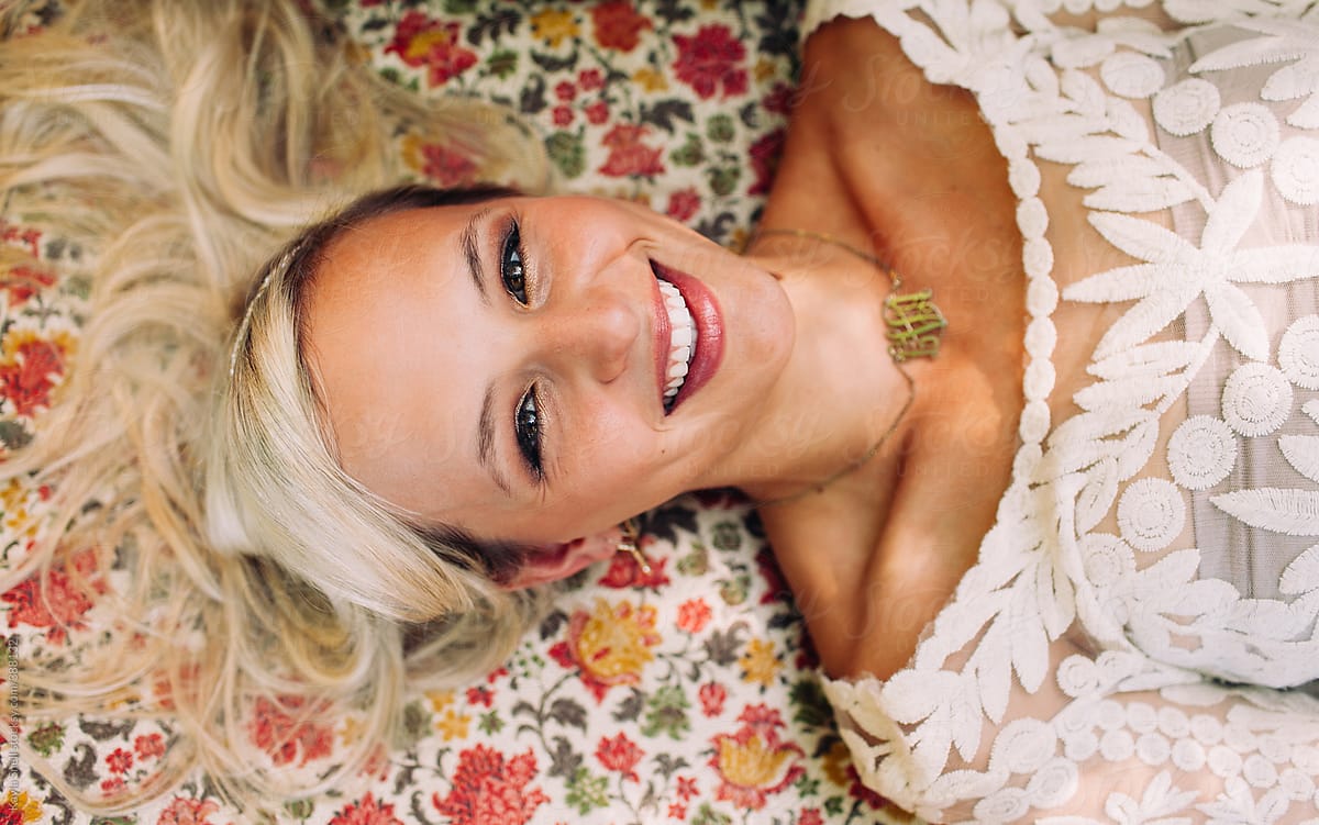Smiling girl laying on a floral couch