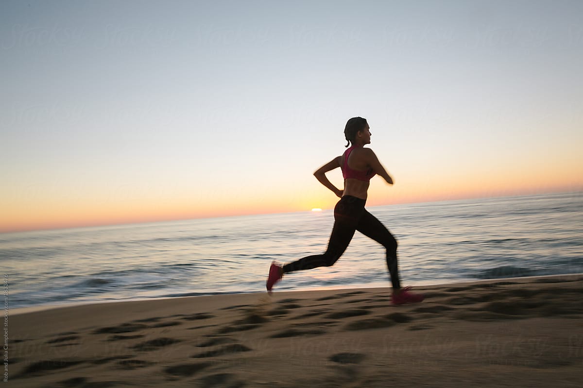 Fit Woman Running And Working Out On The Beach At Sunset By Stocksy Contributor Rob And Julia