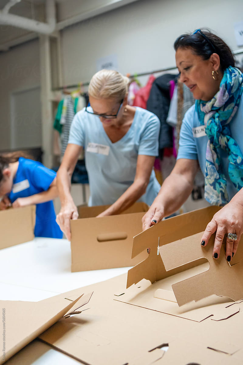 volunteers assembling cardboard gift boxes