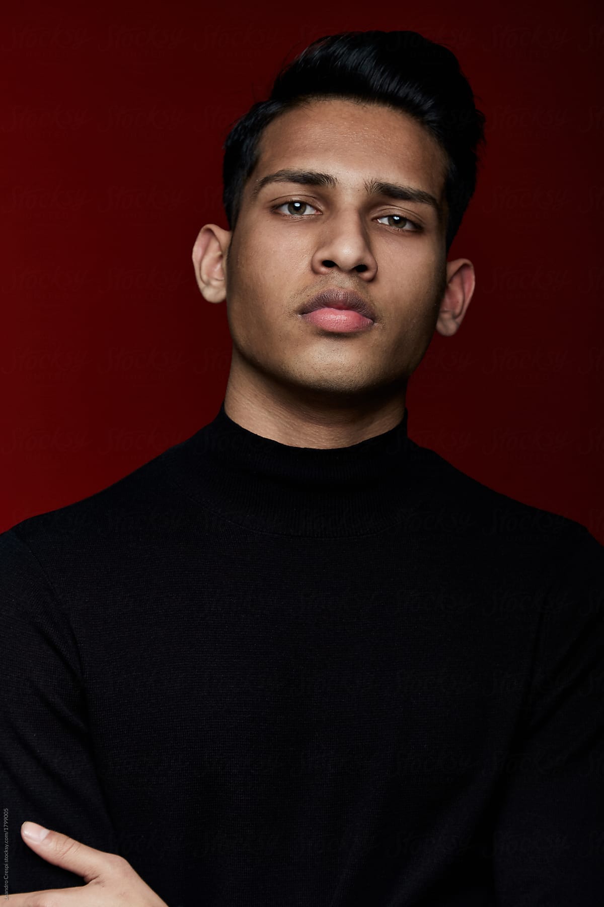 Handsome Indian guy portrait over red background