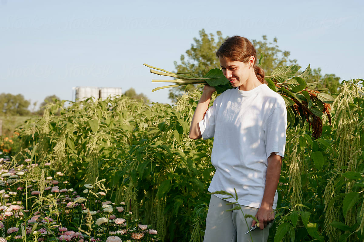 Farmer of flowers with a bouquet in the field