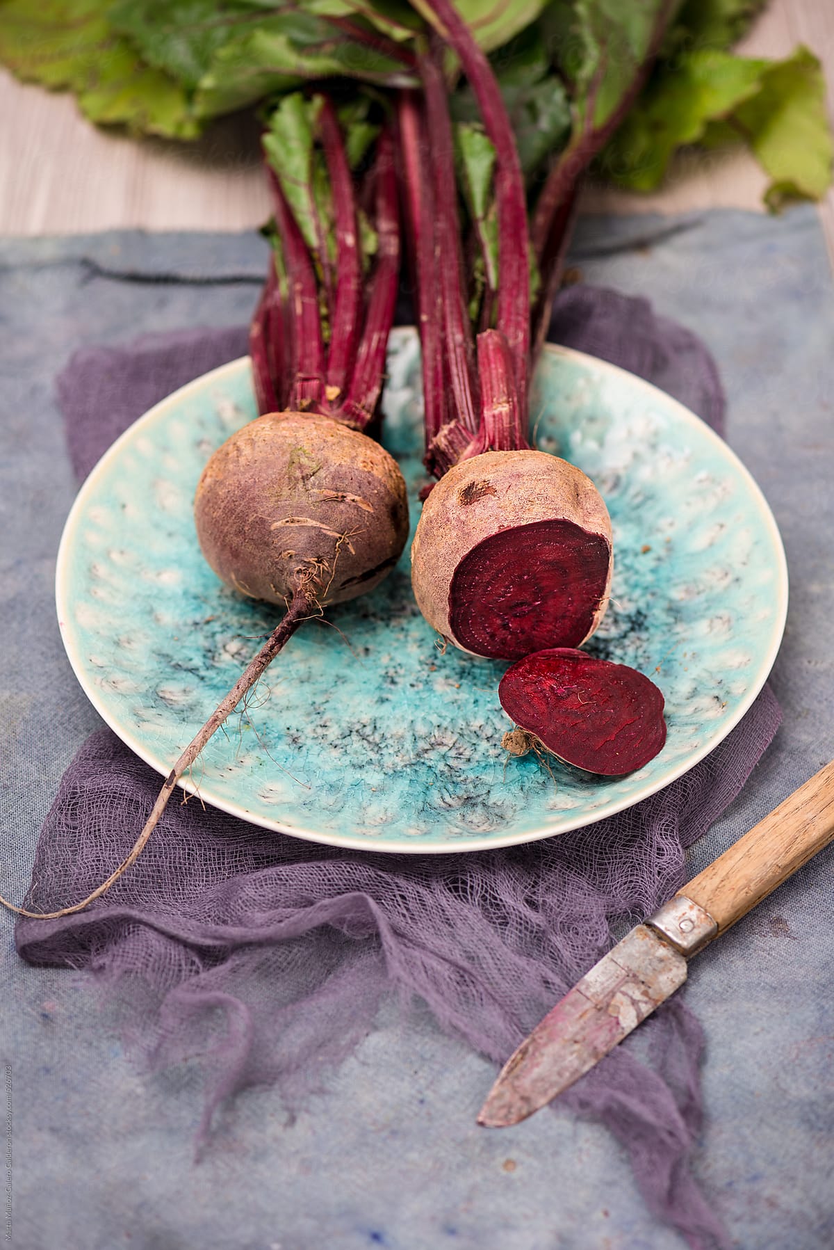 beets on turquoise porcelain plate on a  rustic wood background
