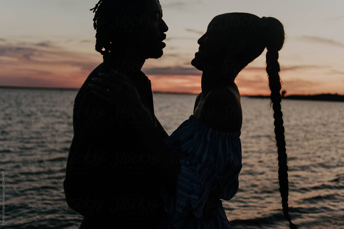 A young engaged african american couple standing by lake Erie in buffalo, ny