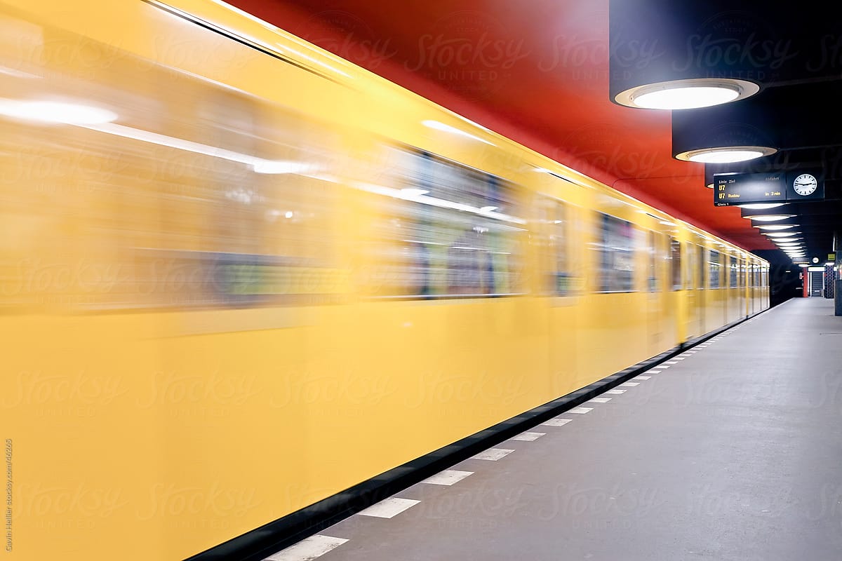Europe, Germany, Berlin, modern subway station  - moving train pulling into the station