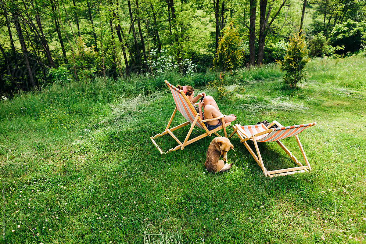 Woman and dog on picnic in nature