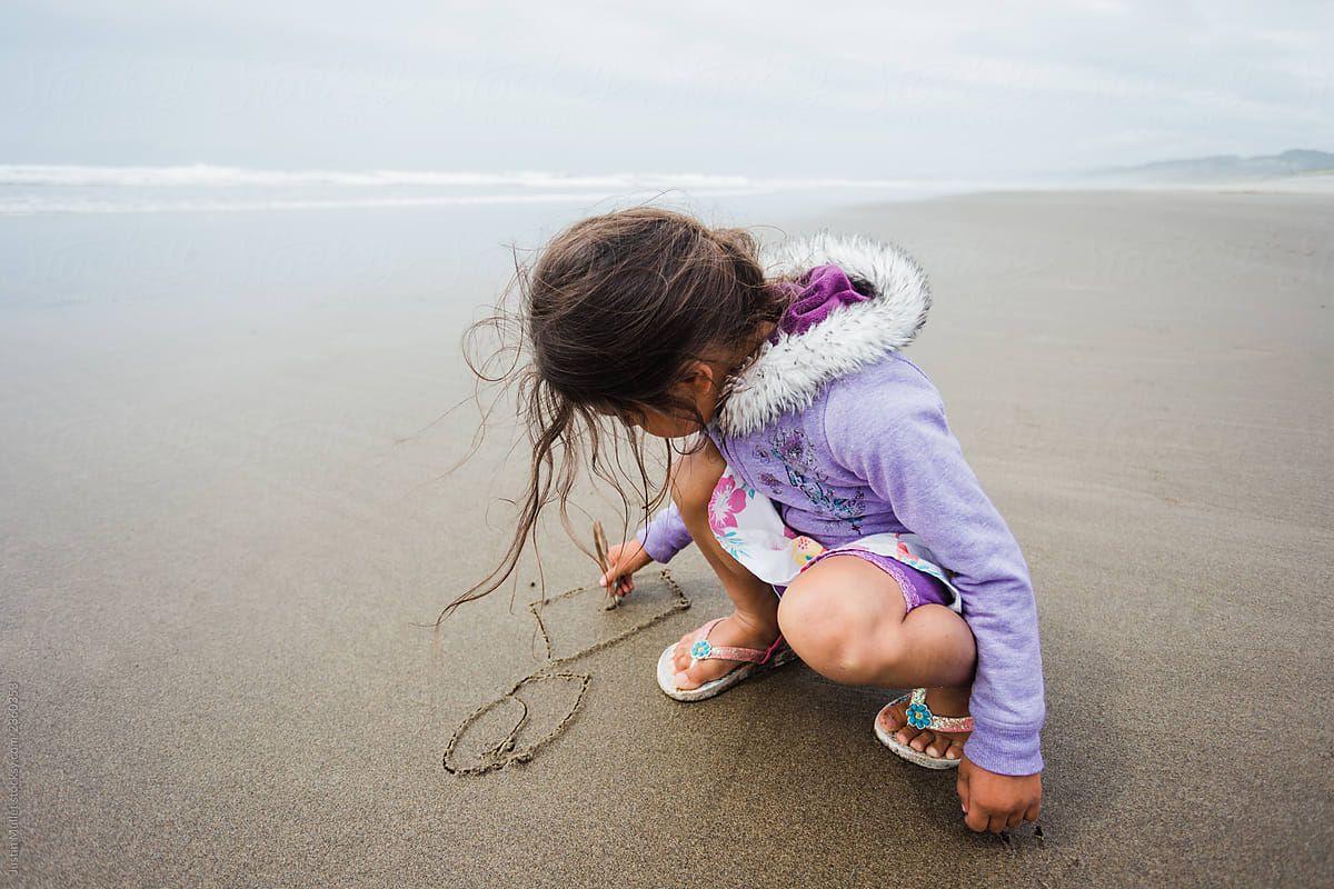 Girl Drawing on the Sand