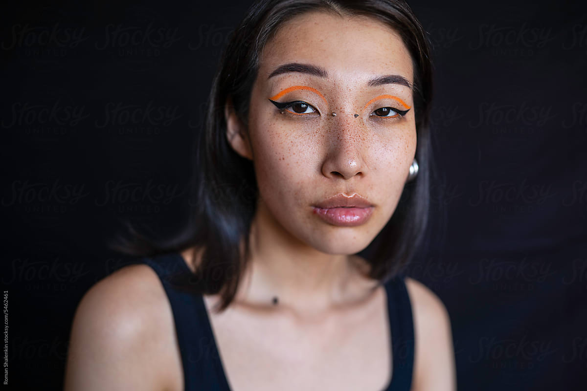 Young woman with makeup and ear piercing