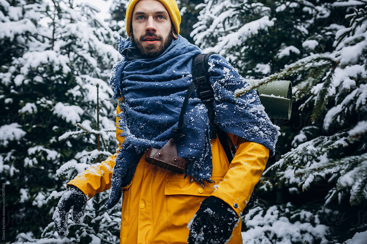 Guy traveling in wide winter forest.