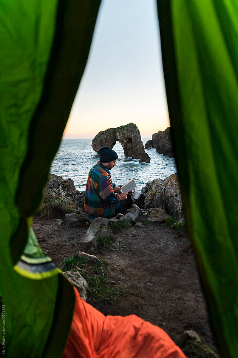 Man camping on seashore