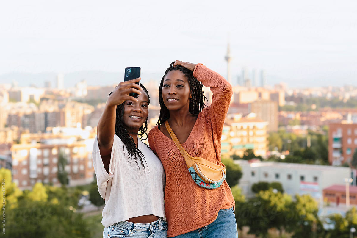 Two young woman taking a selfie outdoors