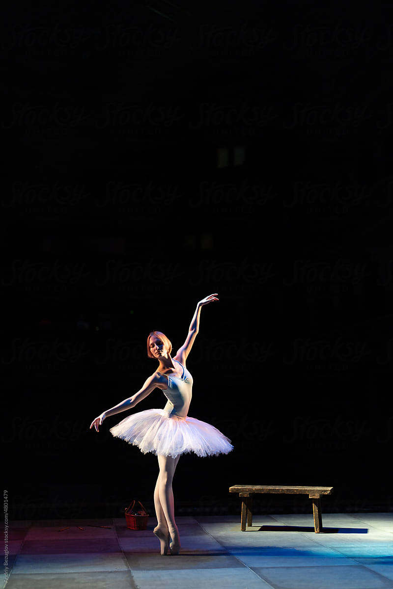Young slim flexible girl ballerina stands in ballet tutu in pose