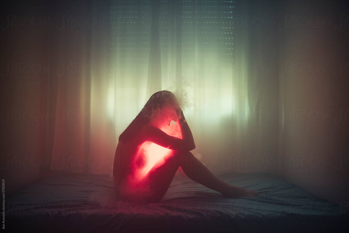 Woman on the bed with red light and smoke
