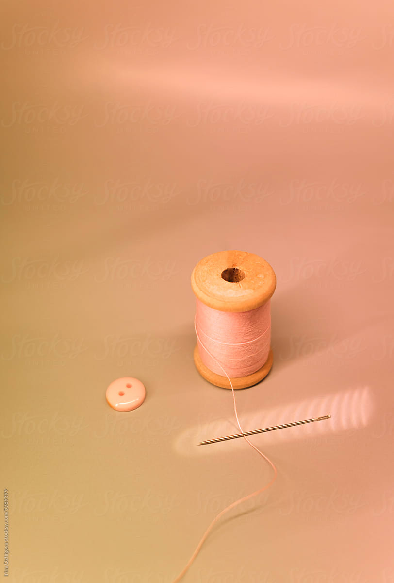 Vintage-Inspired Sewing Equipment on a Peach-Colored Background