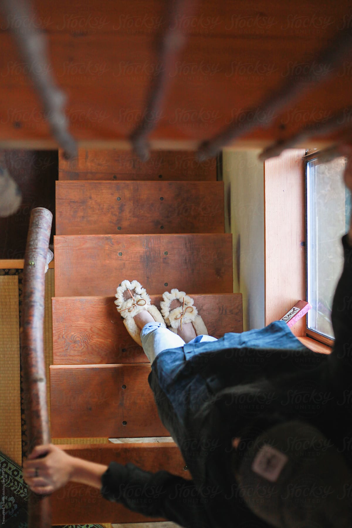 Woman in slippers walking down the stairs