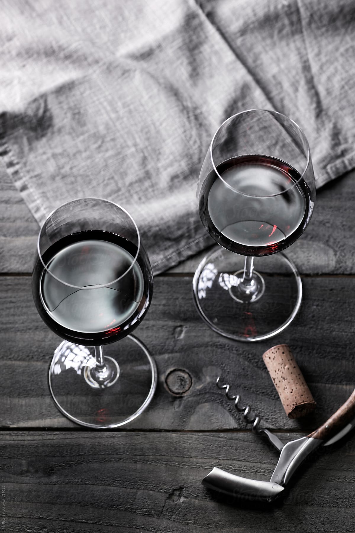 Wine: Two glasses of red wine and corkscrew