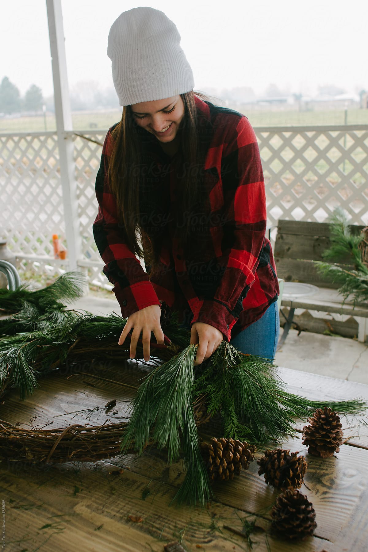 young woman making holiday wreath