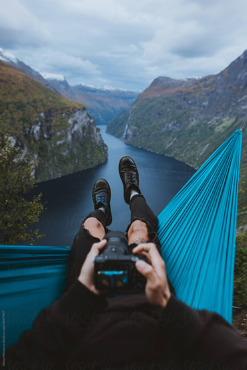 Photographer resting in hammock above river valley