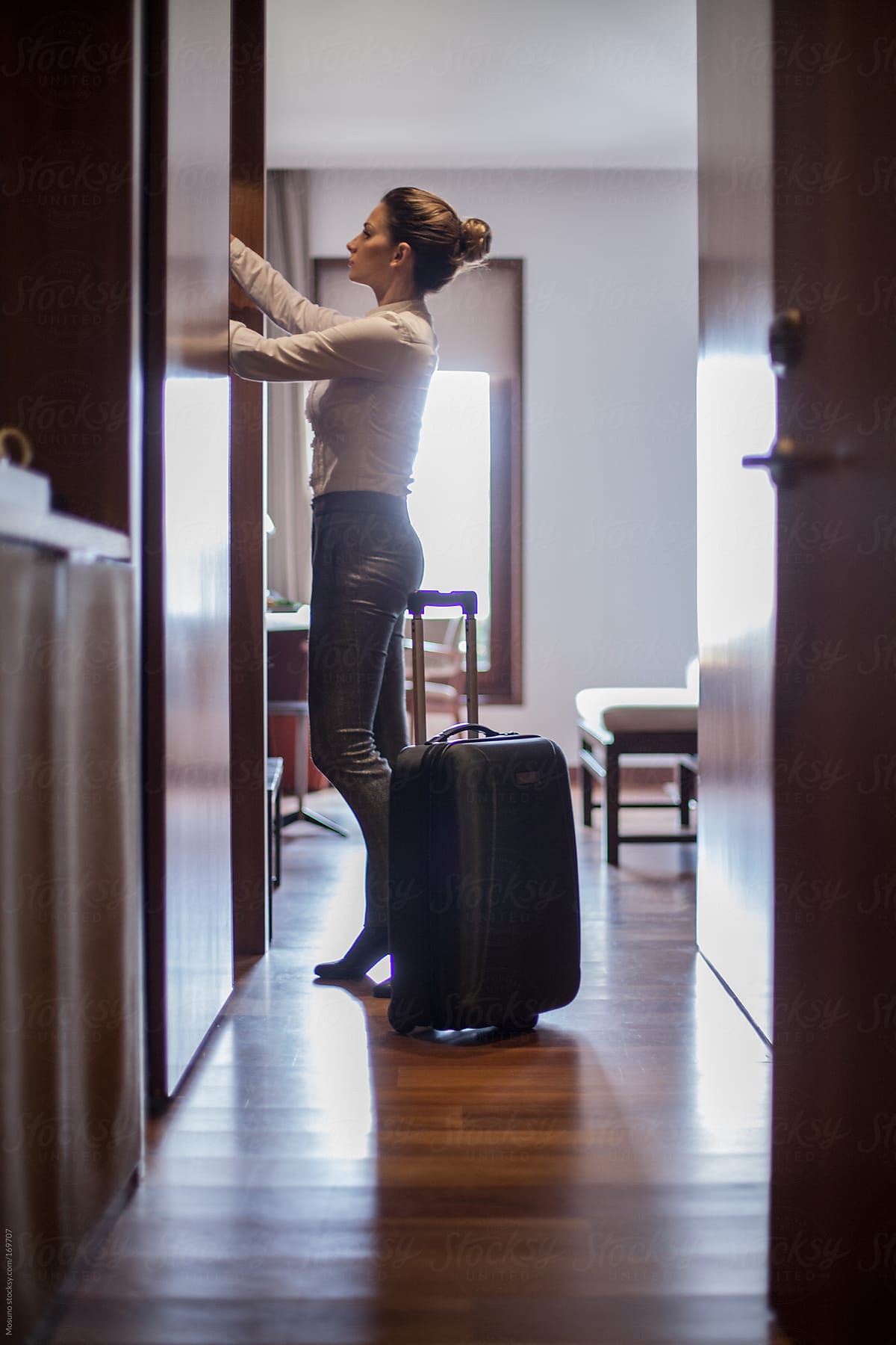 Woman Unpacking in a Hotel Room