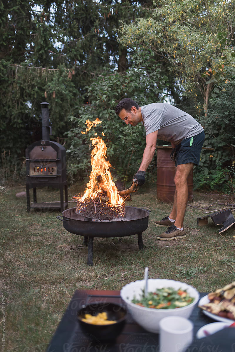 Backyard Chef: Dad Tending to the Garden Fire Pit