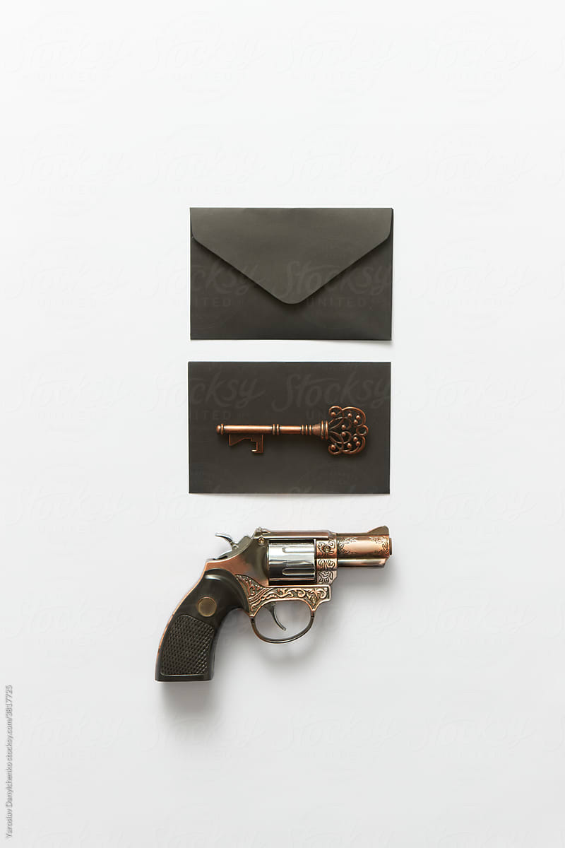 Black envelopes, gun and key