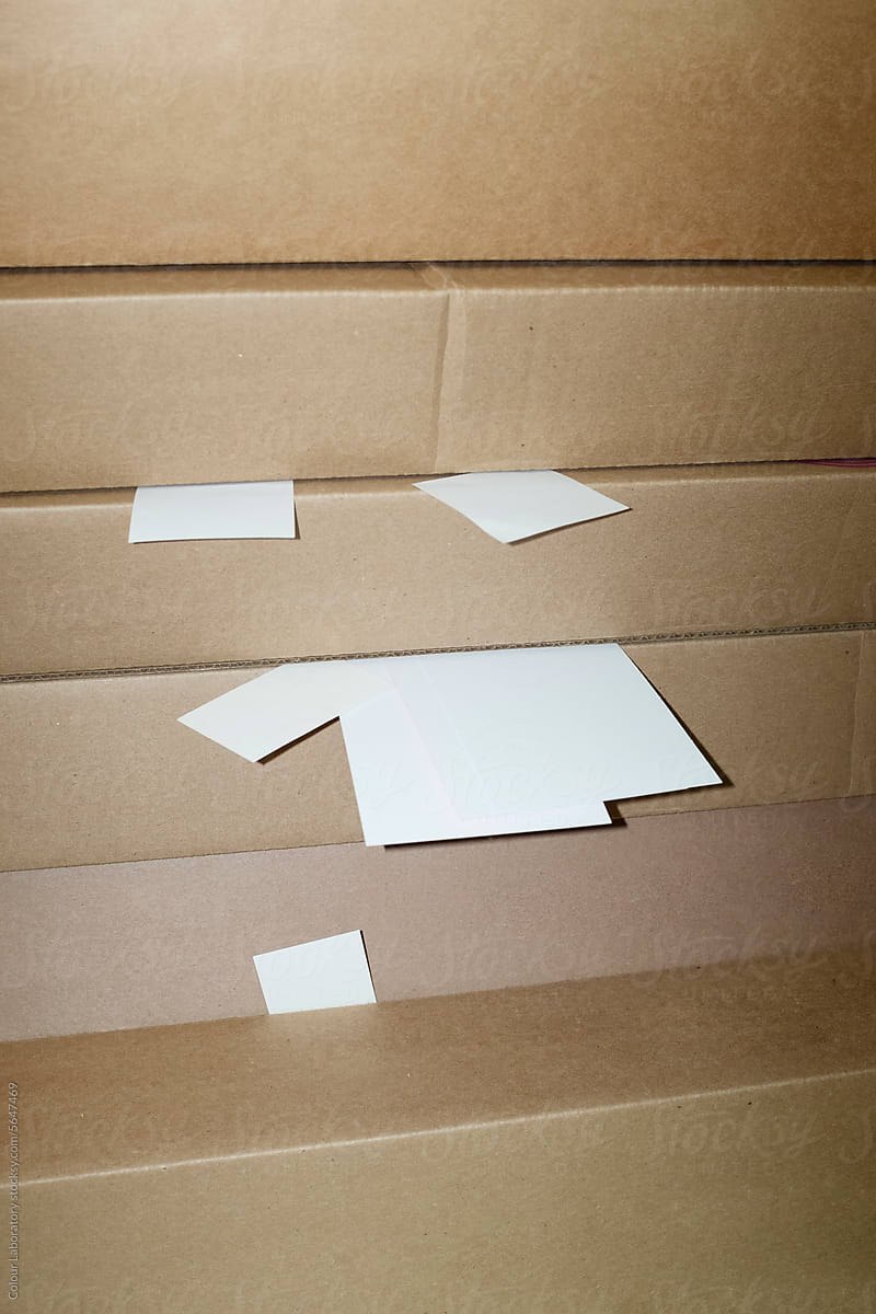 Post-it notes/papers and cardboard boxes with hard direct flashlight