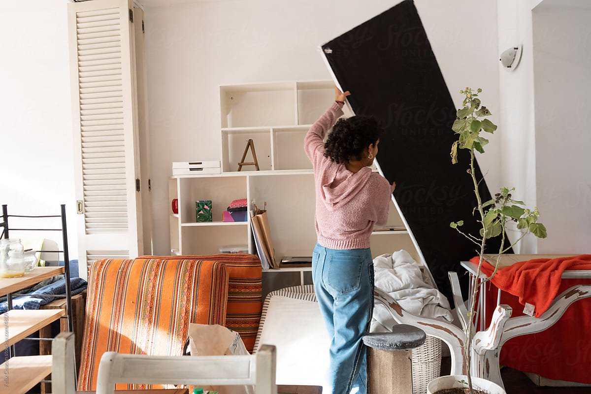 Woman Organizing Things In The Living Room
