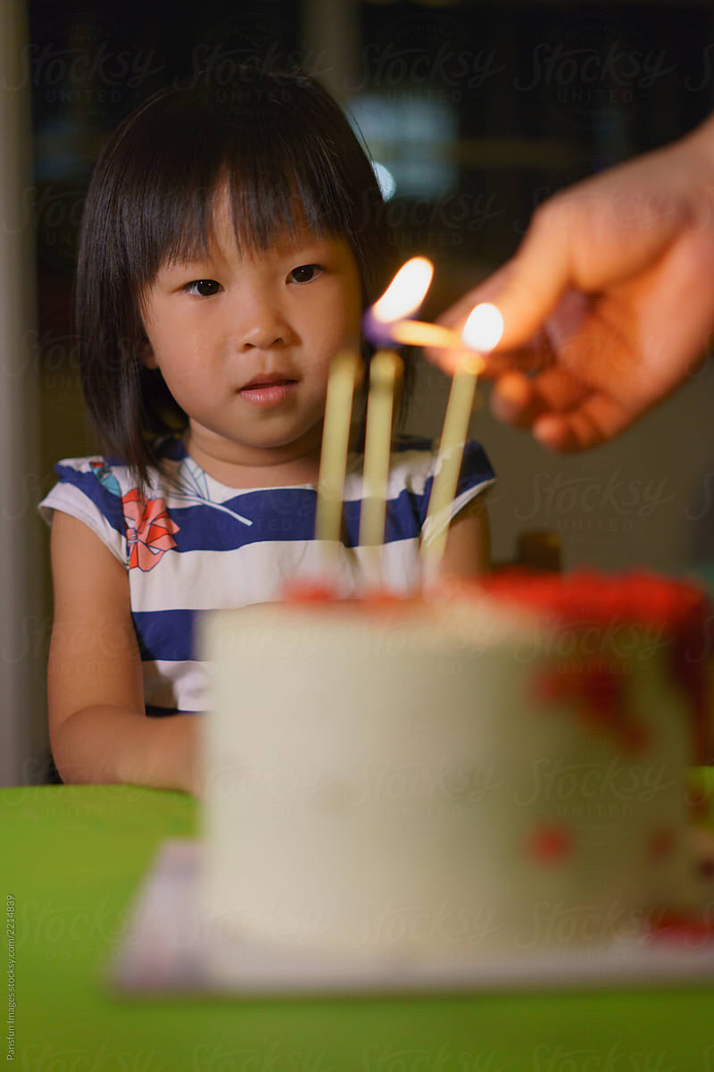 little girl and birthday cake