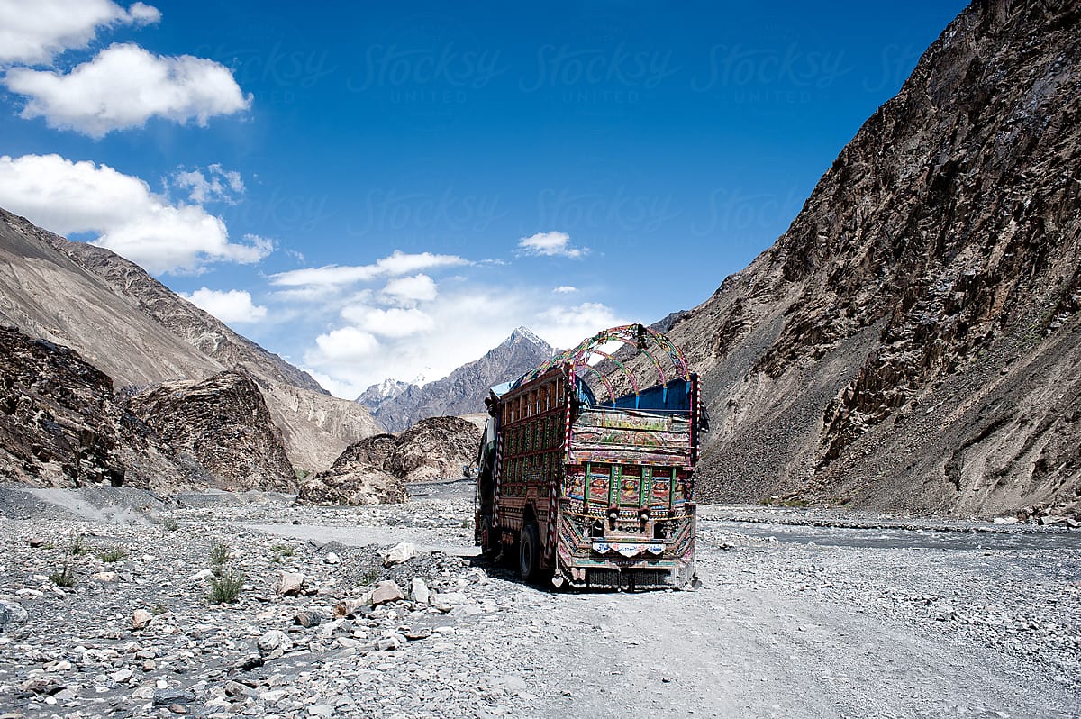 Track in typical indian style on a dirt wild road through the mountain on karakoram highway