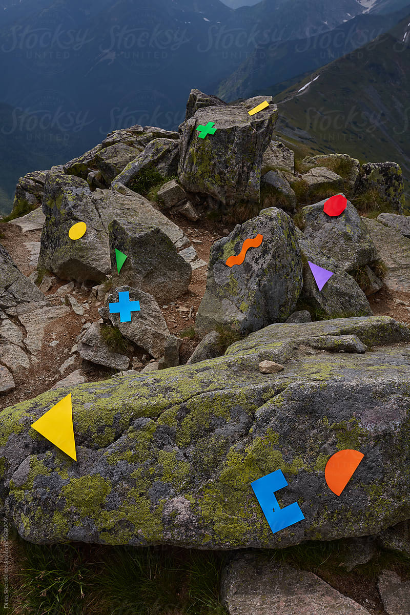 conceptual still life with multicolored figures on rocks