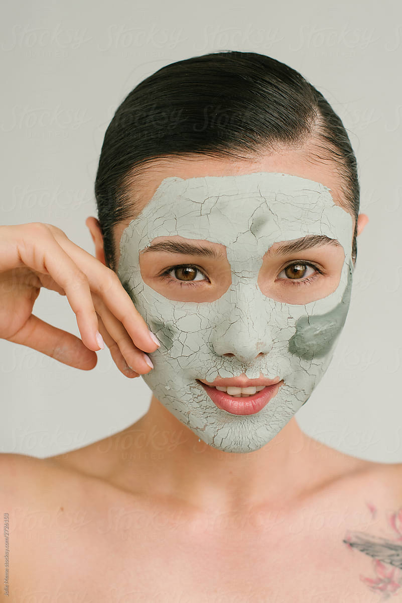 A charming Asian girl with a clay mask